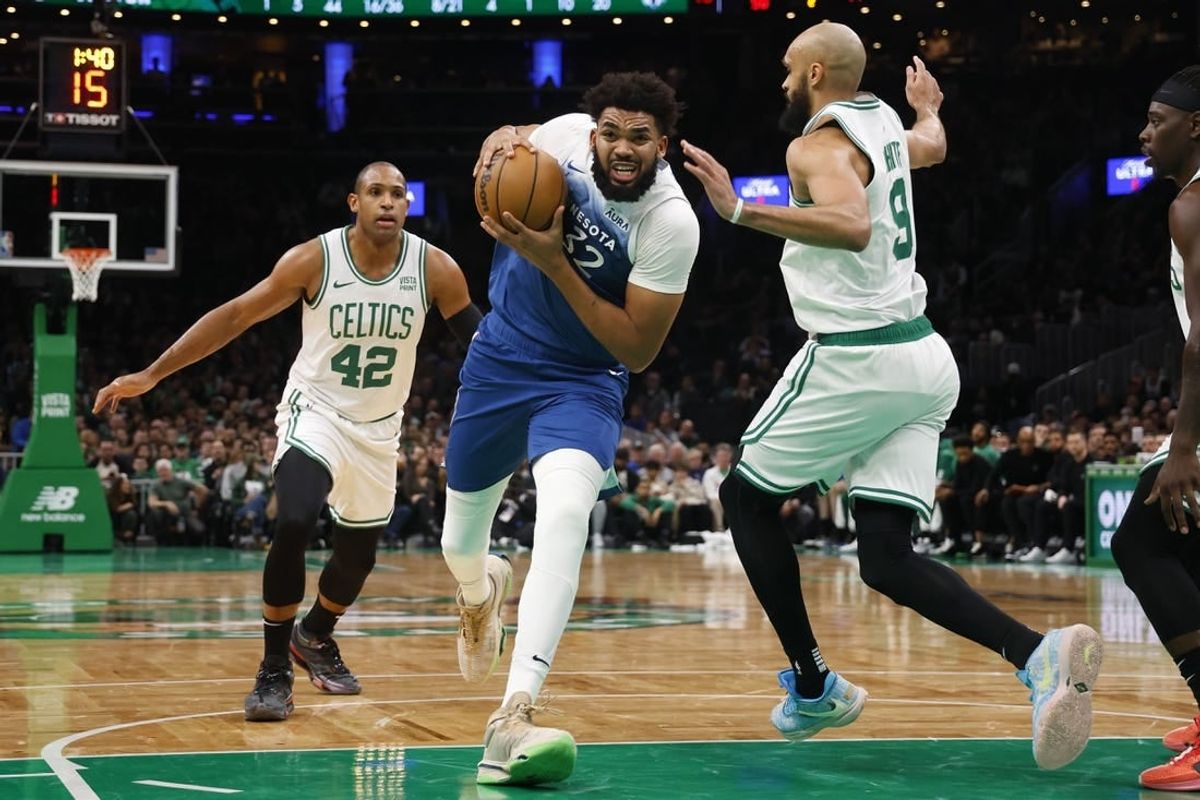 Jan 10, 2024; Boston, Massachusetts, USA; Minnesota Timberwolves center Karl-Anthony Towns (32) drives on Boston Celtics guard Derrick White (9) during the second quarter at TD Garden.