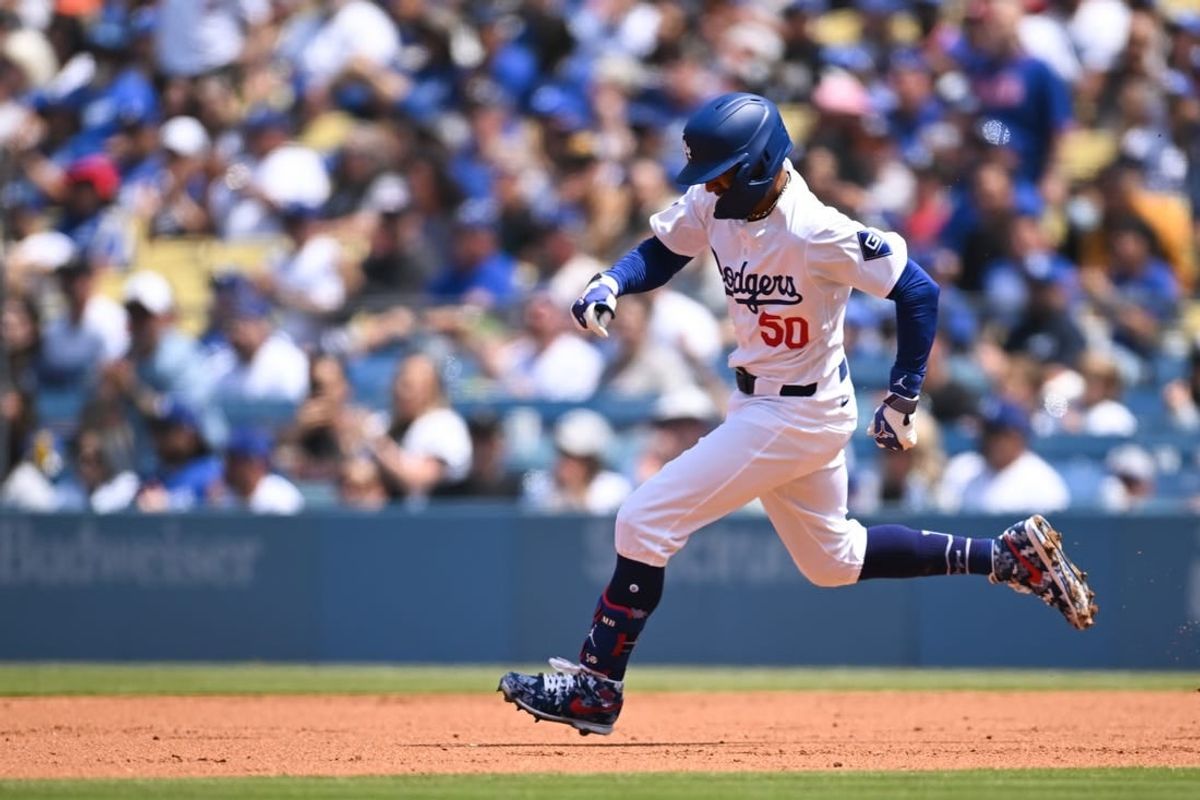 Apr 20, 2024; Los Angeles, California, USA; Los Angeles Dodgers shortstop Mookie Betts (50) doubles against the New York Mets during the first inning at Dodger Stadium.