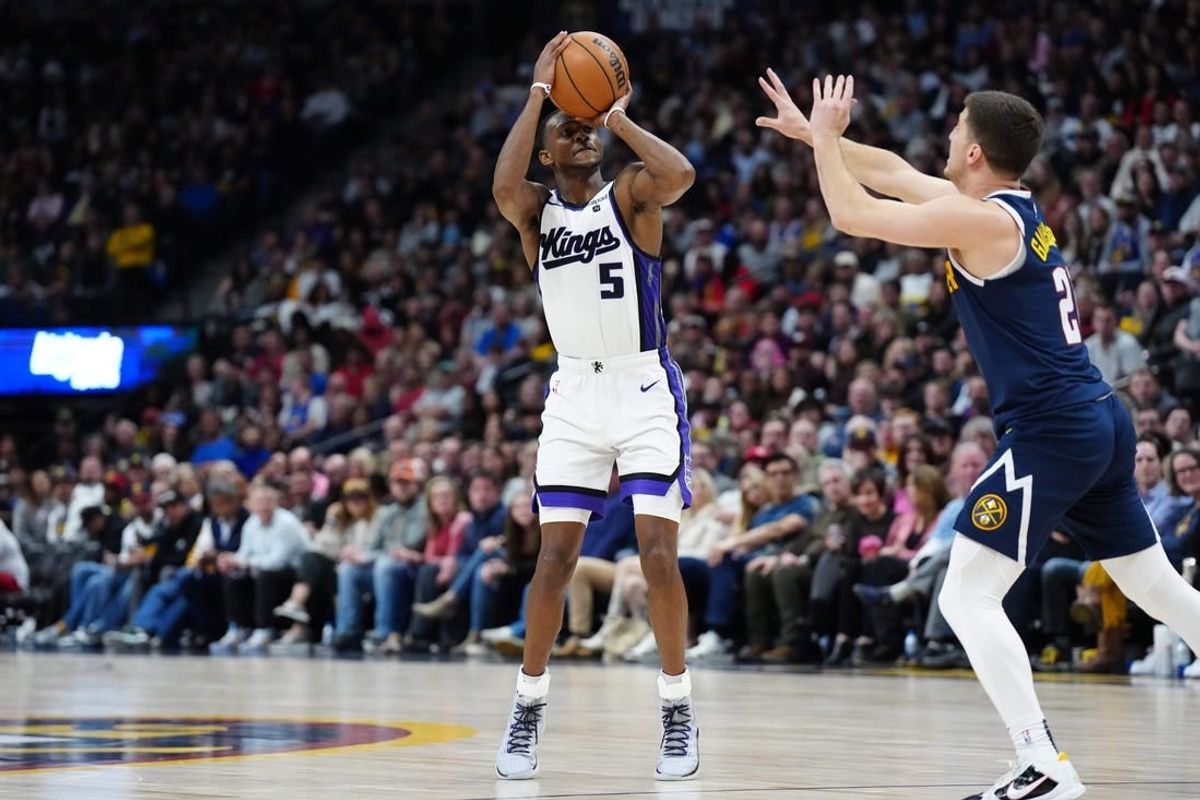 Feb 14, 2024; Denver, Colorado, USA; Sacramento Kings guard De'Aaron Fox (5) shoots the ball over Denver Nuggets guard Collin Gillespie (21) in the second half at Ball Arena.