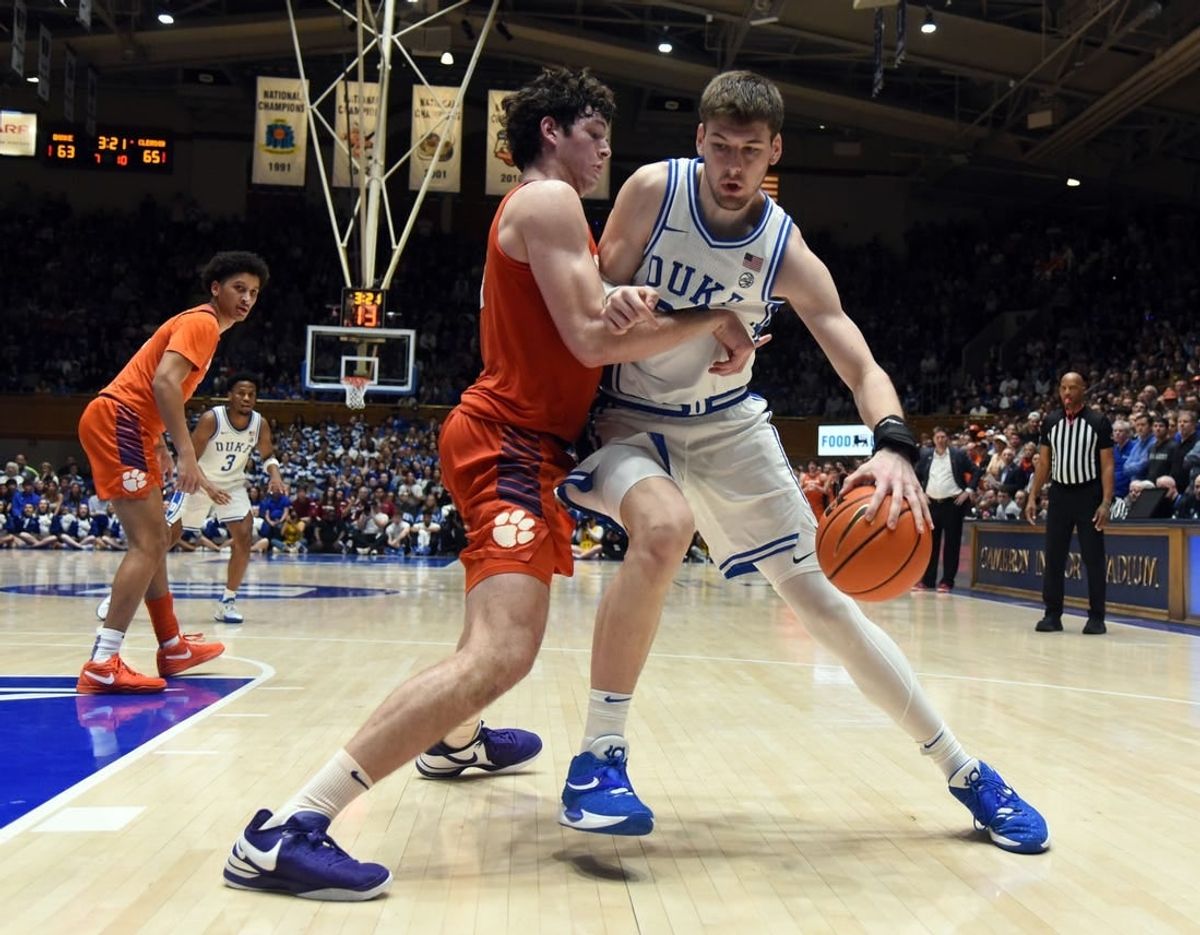 Jan 27, 2024; Durham, North Carolina, USA; Duke Blue Devils center Kyle Filipowski (30) controls the ball in front of Clemson Tigers center PJ Hall (24) during the second half at Cameron Indoor Stadium.