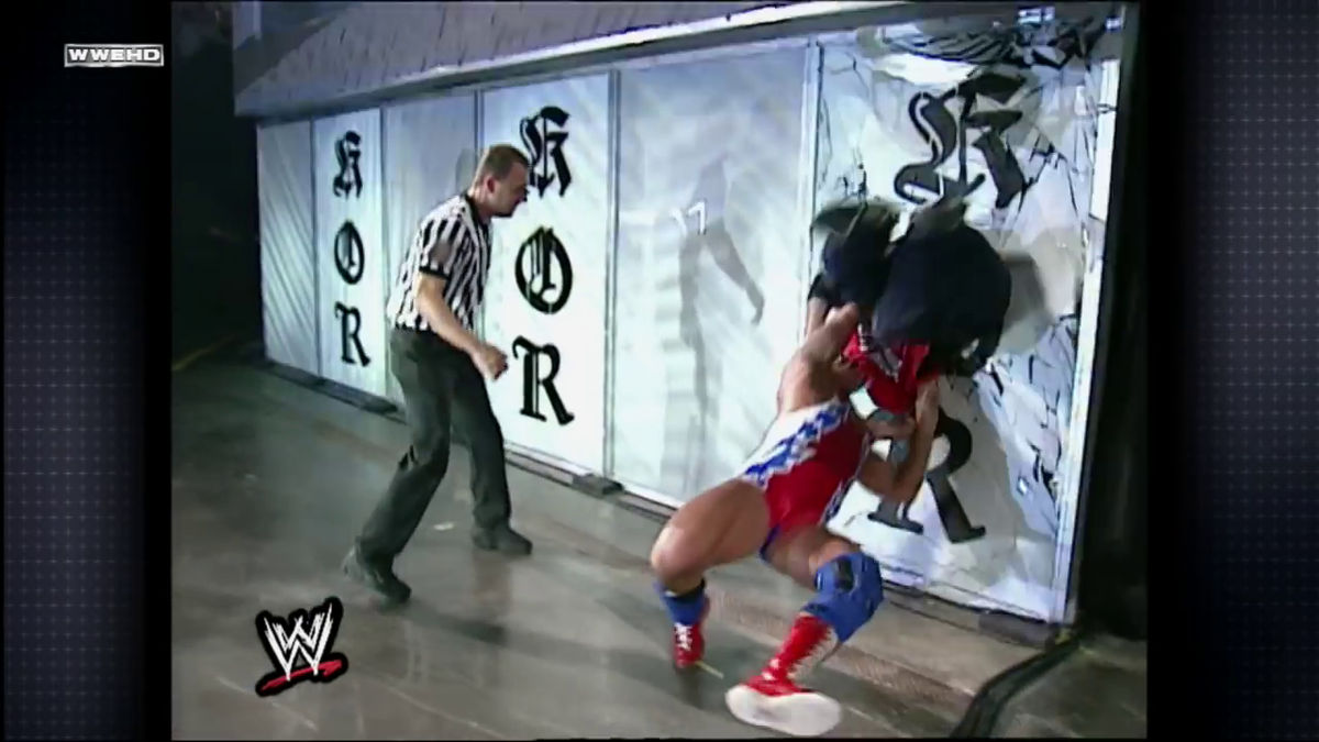 Kurt Angle — with a broken tailbone — suplexes Shane McMahon through a pane of glass.