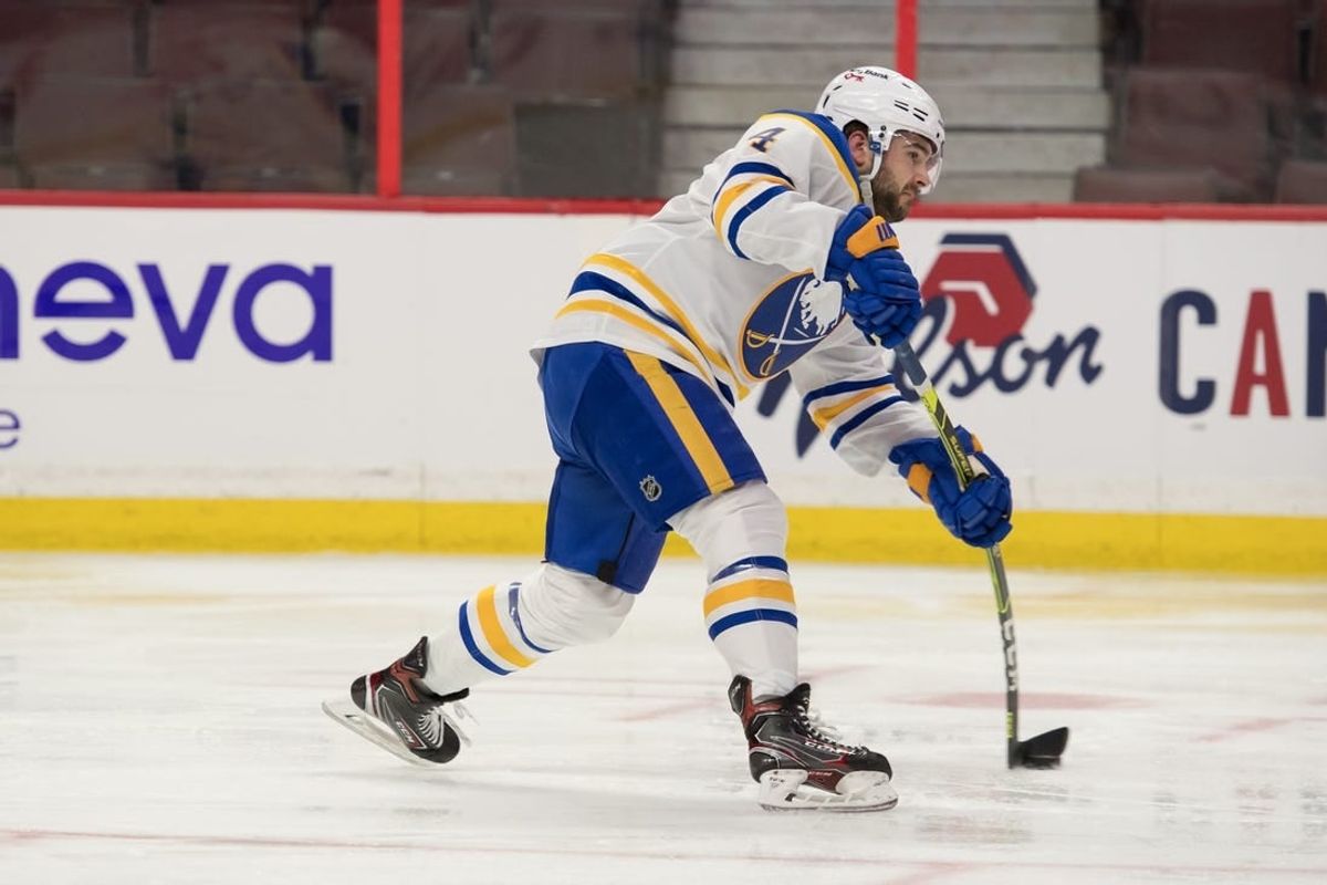 Jan 18, 2022; Ottawa, Ontario, CAN; Buffalo Sabres defenseman Will Butcher (4) shoots the puck in the second period against the Ottawa Senators at the Canadian Tire Centre.