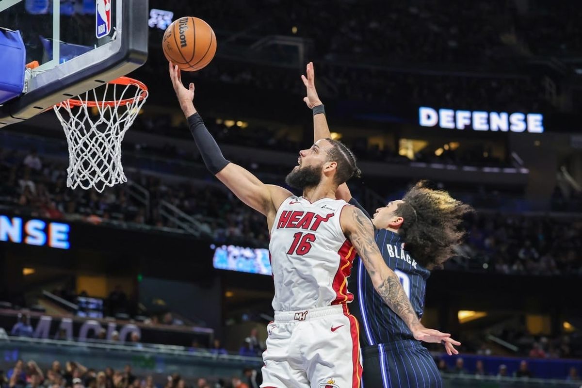 Jan 21, 2024; Orlando, Florida, USA; Miami Heat forward Caleb Martin (16) goes to the basket against Orlando Magic guard Anthony Black (0) during the second quarter at Amway Center.