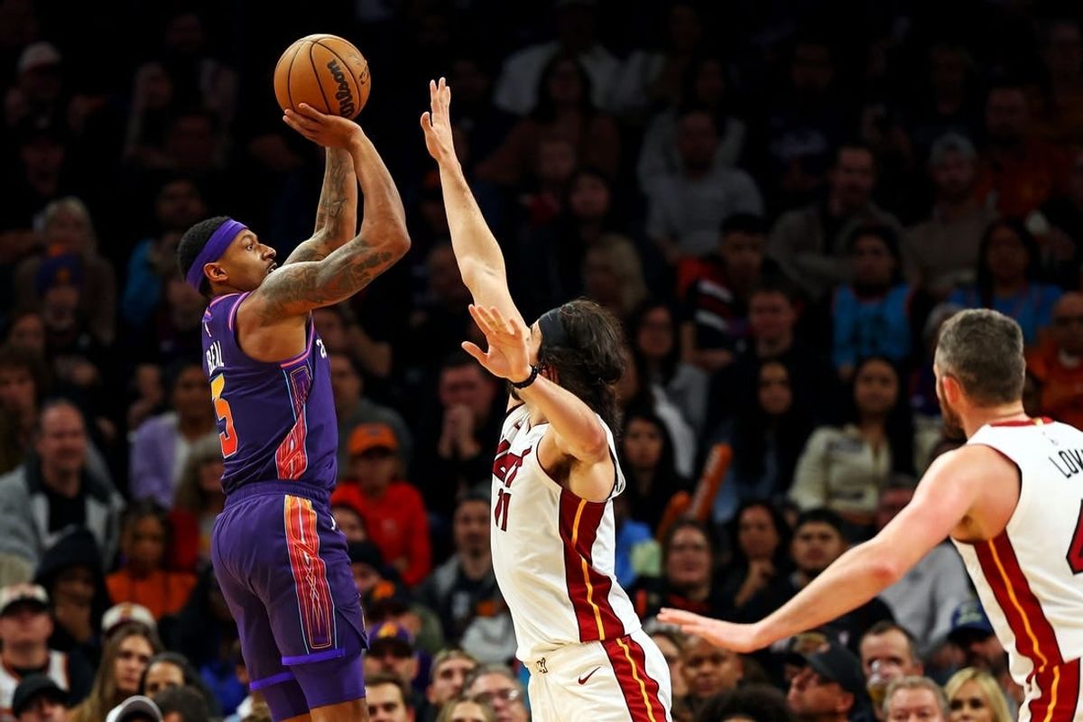 Jan 5, 2024; Phoenix, Arizona, USA; Phoenix Suns guard Bradley Beal (3) shoots the ball against Miami Heat guard Jaime Jaquez Jr. (11) during the fourth quarter at Footprint Center.