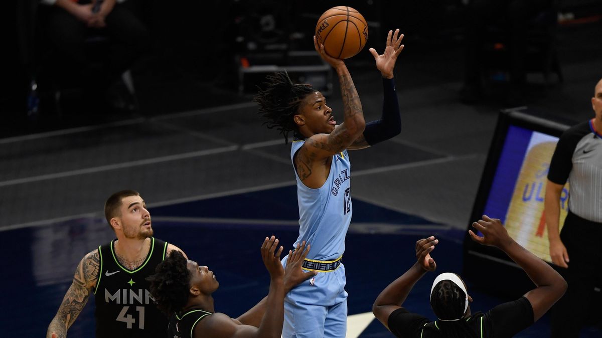 Ja Morant of Memphis shoots the ball against Juancho Hernangomez, Anthony Edwards, and Naz Reid of Minnesota during the third quarter of the game at Target Center on May 5, 2021, in Minneapolis, Minnesota.