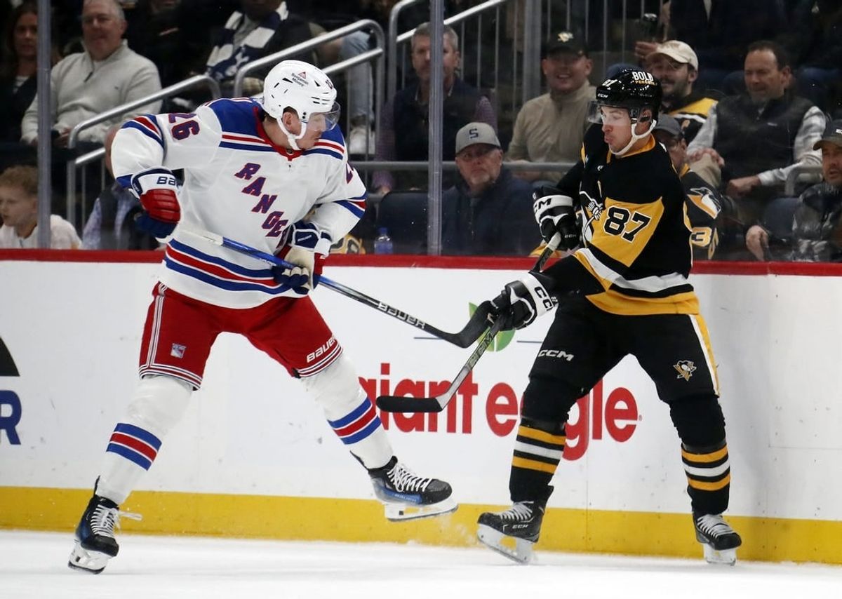Nov 22, 2023; Pittsburgh, Pennsylvania, USA; New York Rangers left wing Jimmy Vesey (26) and Pittsburgh Penguins center Sidney Crosby (87) battle for the puck during the second period at PPG Paints Arena.