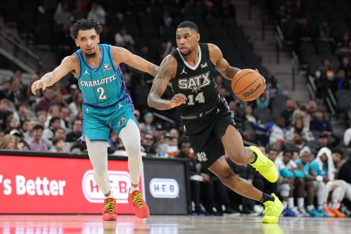 Jan 12, 2024; San Antonio, Texas, USA;  San Antonio Spurs guard Blake Wesley (14) dribbles against Charlotte Hornets guard James Bouknight (2) in the second half at Frost Bank Center.
