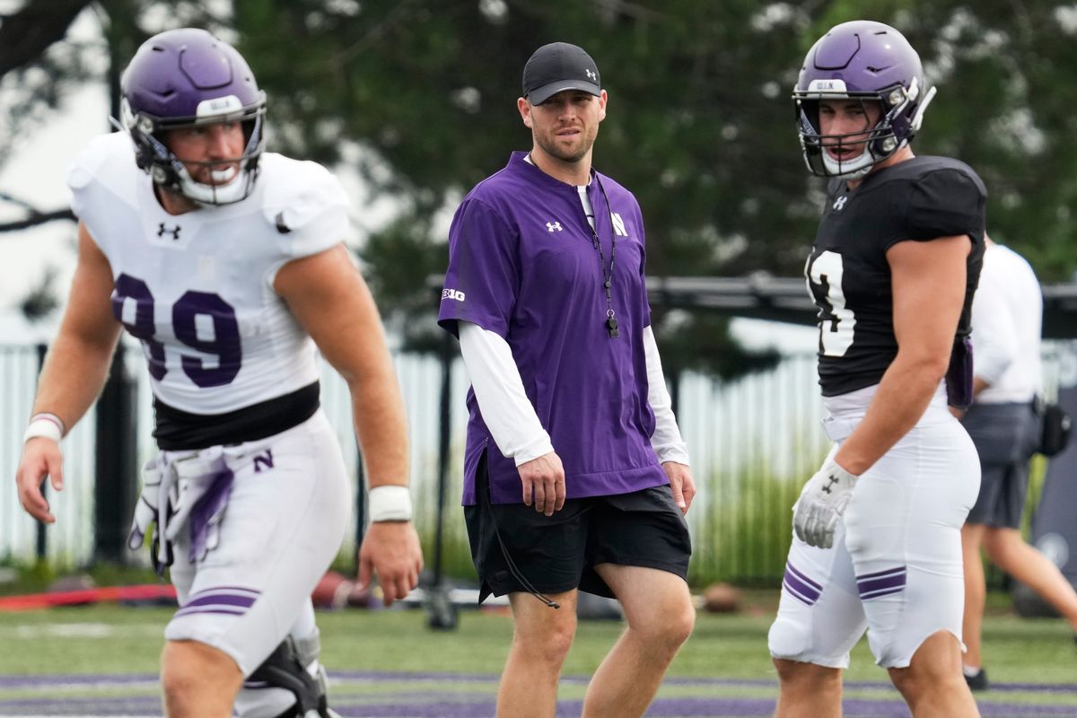 Northwestern interim head coach David Braun (center) watches players during the team's practice