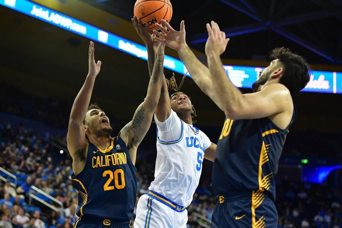 Jan 6, 2024; Los Angeles, California, USA; UCLA Bruins guard Brandon Williams (5) plays for the rebound against California Golden Bears guard Jaylon Tyson (20) and forward Fardaws Aimaq (00) during the first half at Pauley Pavilion.