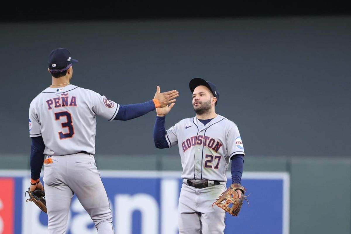 Oct 10, 2023; Minneapolis, Minnesota, USA; Houston Astros second baseman Jose Altuve (27) and shortstop Jeremy Pena (3) celebrates defeating Minnesota Twins  during game three of the ALDS for the 2023 MLB playoffs at Target Field.