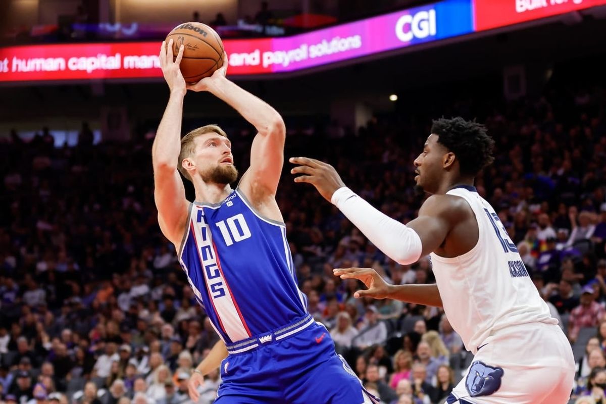 Mar 18, 2024; Sacramento, California, USA; Sacramento Kings forward Domantas Sabonis (10) shoots the ball against Memphis Grizzlies forward Jaren Jackson Jr. (13) during the first quarter at Golden 1 Center.