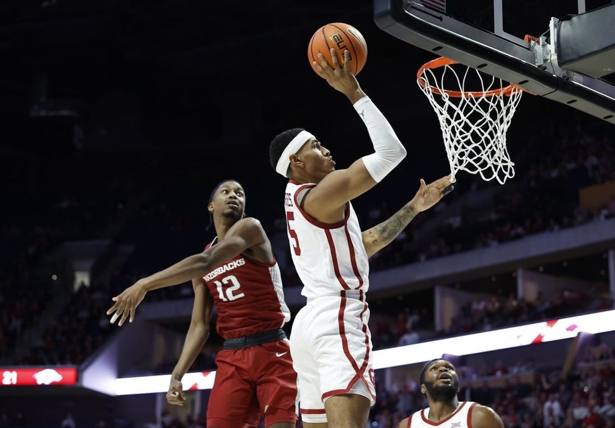 Dec 9, 2023; Tulsa, Oklahoma, USA; Oklahoma Sooners guard Rivaldo Soares (5) shoots beside Arkansas Razorbacks guard Tramon Mark (12) during the first half at BOK Center.
