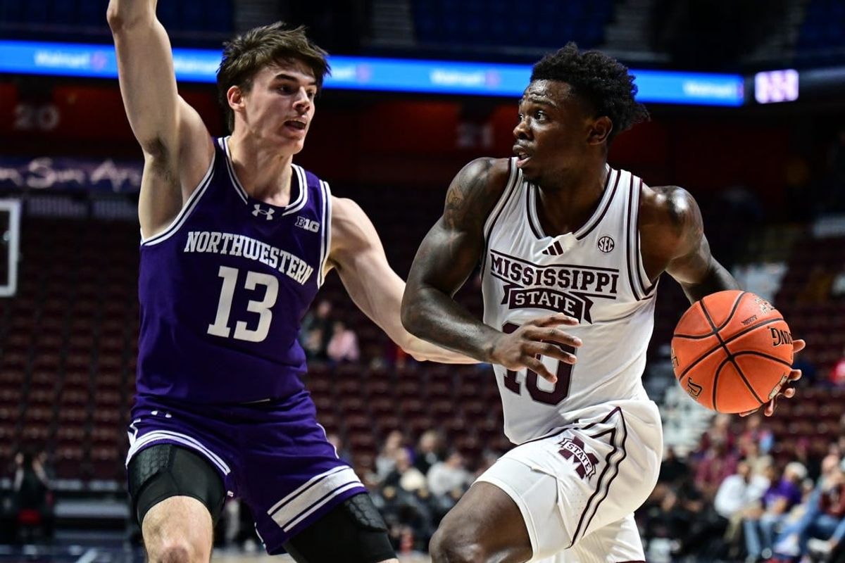Nov 19, 2023; Uncasville, CT, USA; Mississippi State Bulldogs guard Josh Hubbard (13) looks to shoot the ball defended by Northwestern Wildcats guard Brooks Barnhizer (13) during the second half at Mohegan Sun Arena.