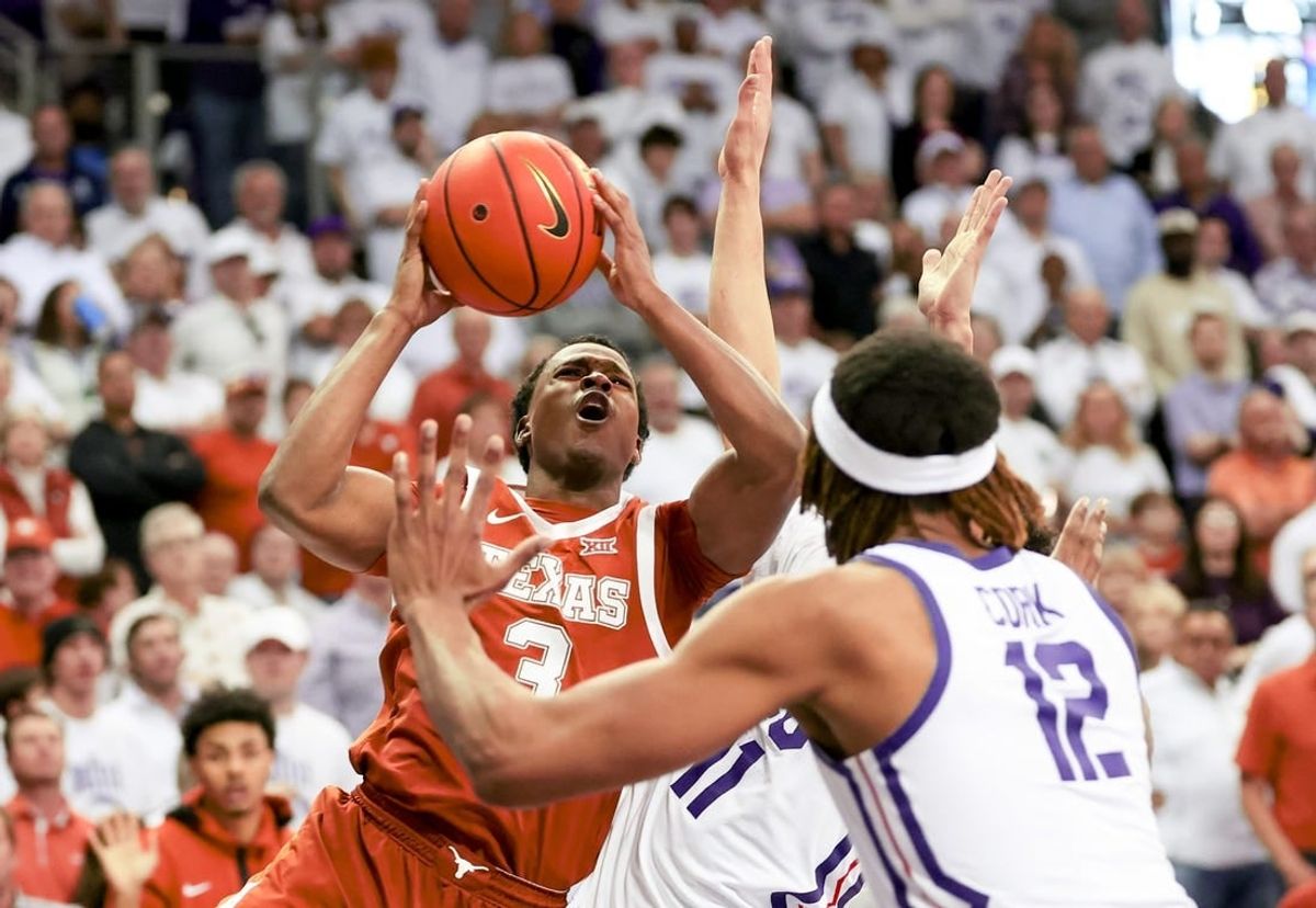 Feb 3, 2024; Fort Worth, Texas, USA;  Texas Longhorns guard Max Abmas (3) shoots as TCU Horned Frogs guard Trevian Tennyson (11) and TCU Horned Frogs forward Xavier Cork (12) defend during the second half at Ed and Rae Schollmaier Arena.