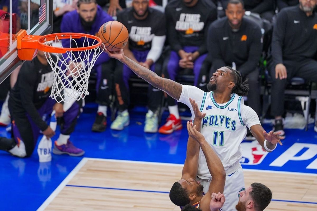 Apr 23, 2024; Minneapolis, Minnesota, USA; Minnesota Timberwolves center Naz Reid (11) shoots against the Phoenix Suns in the third quarter during game two of the first round for the 2024 NBA playoffs at Target Center.