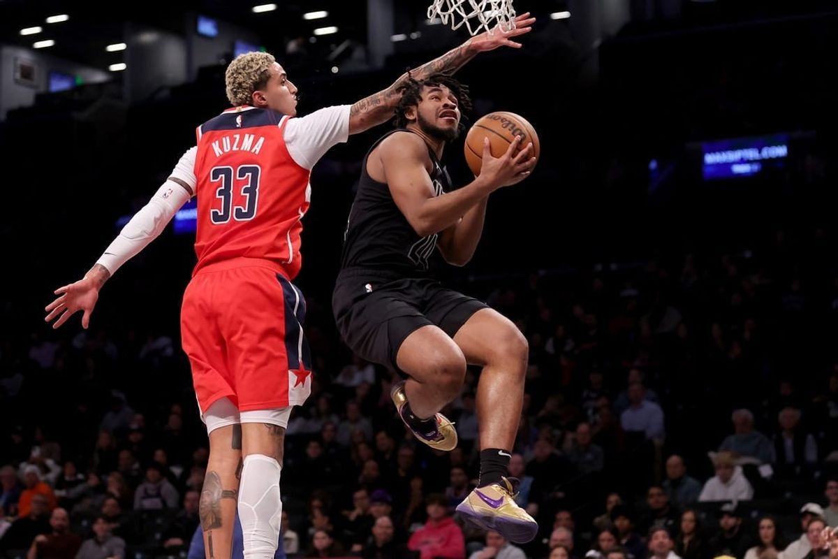 Dec 8, 2023; Brooklyn, New York, USA; Brooklyn Nets guard Cam Thomas (24) drives to the basket against Washington Wizards forward Kyle Kuzma (33) during the first quarter at Barclays Center.