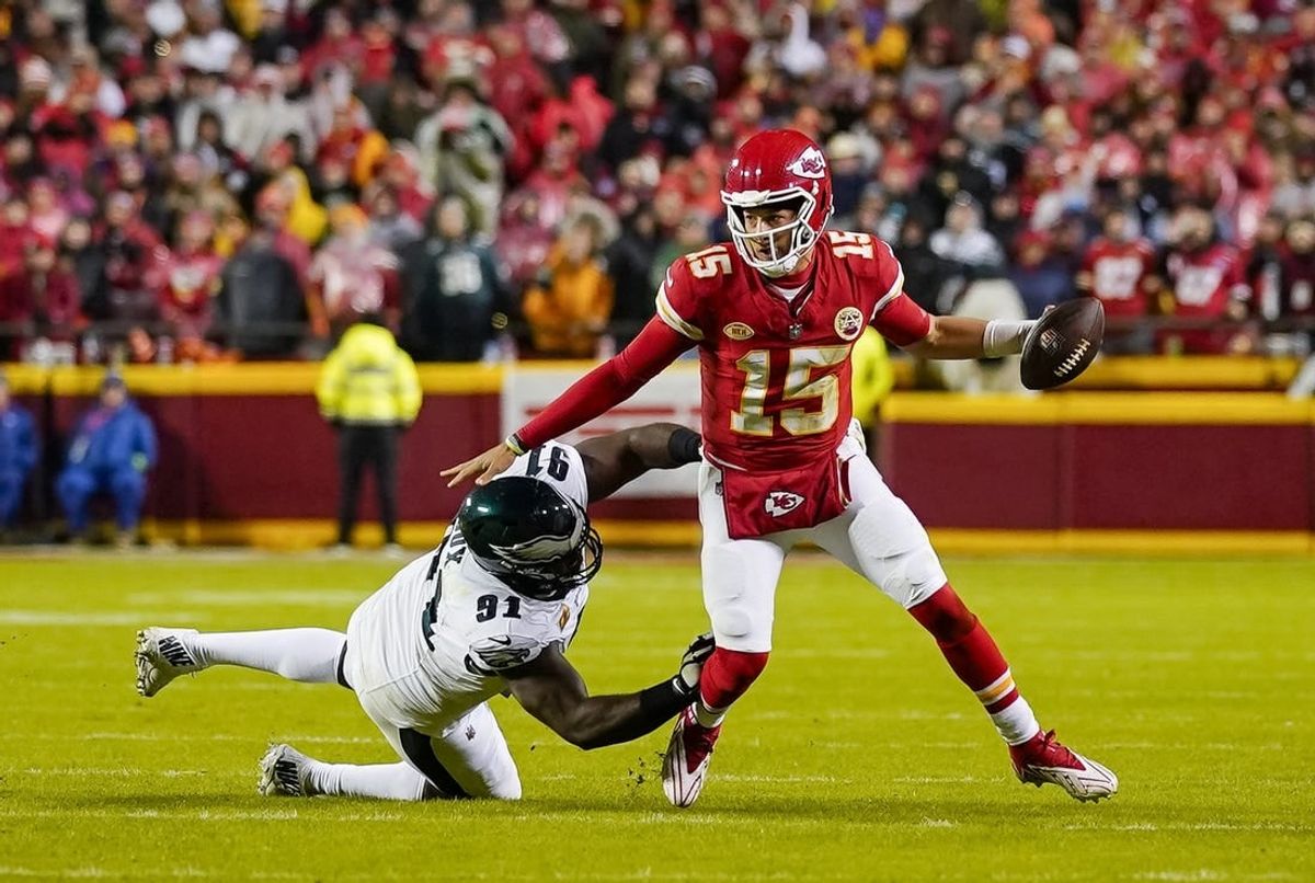 Nov 20, 2023; Kansas City, Missouri, USA; Kansas City Chiefs quarterback Patrick Mahomes (15) scrambles against Philadelphia Eagles defensive tackle Fletcher Cox (91) during the first half at GEHA Field at Arrowhead Stadium.
