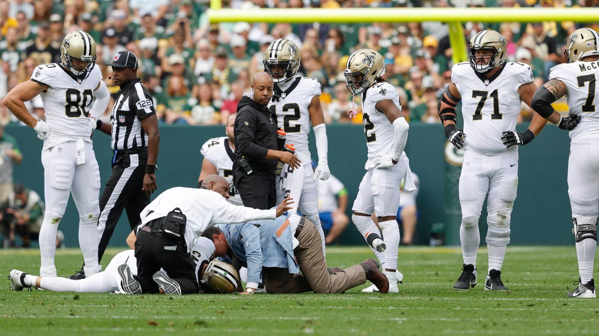 Derek Carr is tended to after falling to a shoulder injury.