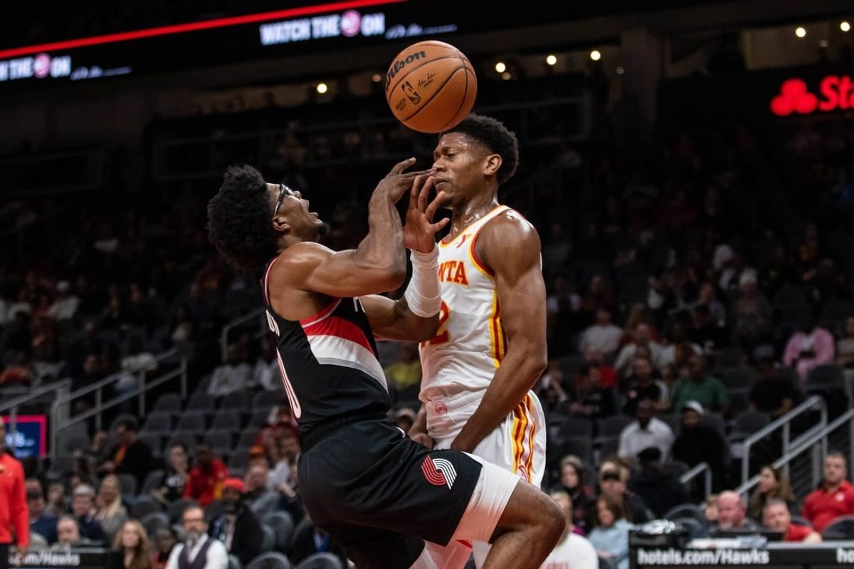 Mar 27, 2024; Atlanta, Georgia, USA; Atlanta Hawks forward De'Andre Hunter (12) defends the basket against Portland Trail Blazers guard Scoot Henderson (00) during the first quarter at State Farm Arena.