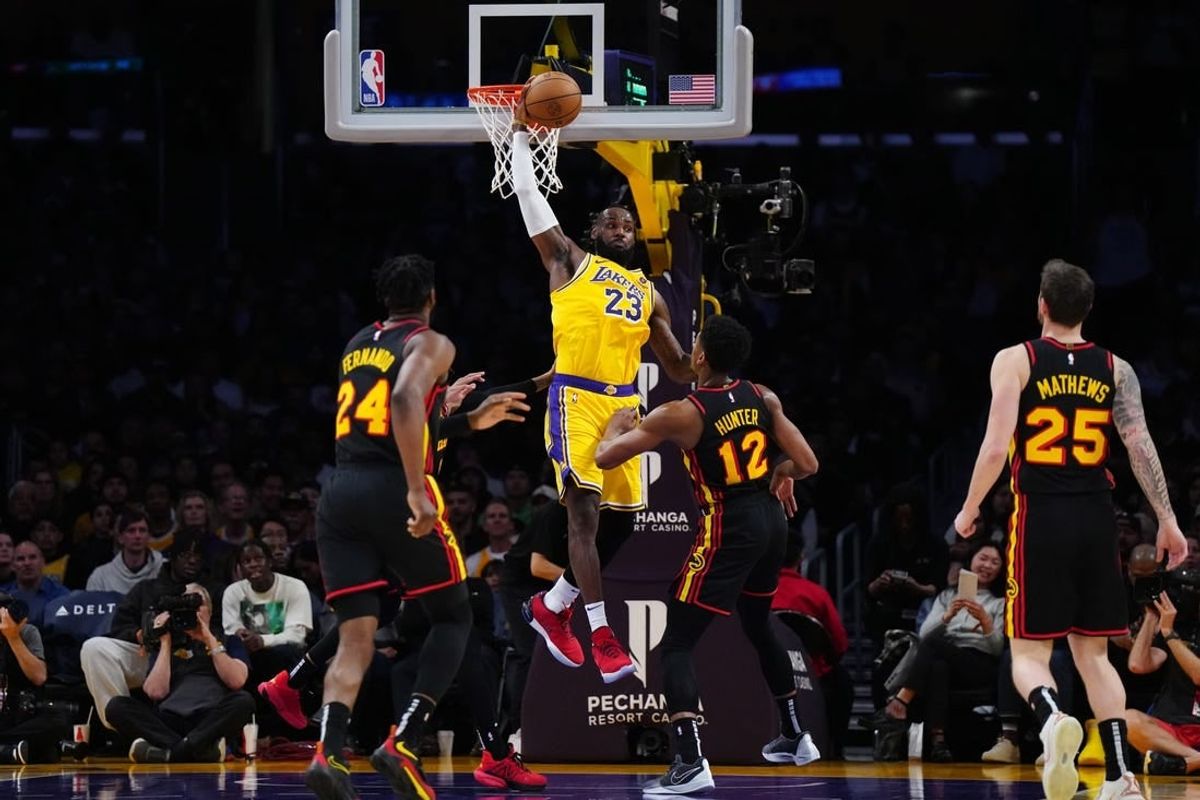 Mar 18, 2024; Los Angeles, California, USA; Los Angeles Lakers forward LeBron James (23) reaches for the ball against Atlanta Hawks forward Bruno Fernando (24), Atlanta Hawks forward De'Andre Hunter (12) and guard Garrison Mathews (25) in the first half at Crypto.com Arena.
