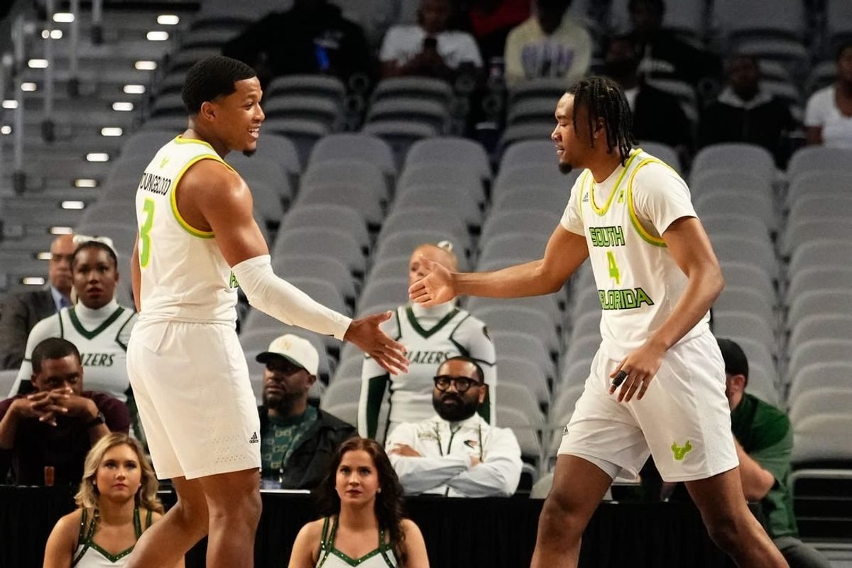 Mar 16, 2024; Fort Worth, TX, USA;  South Florida Bulls guard Kobe Knox (4) celebrates with South Florida Bulls guard Chris Youngblood (3) after scoring a three point basket against the UAB Blazers during the first half at Dickies Arena.