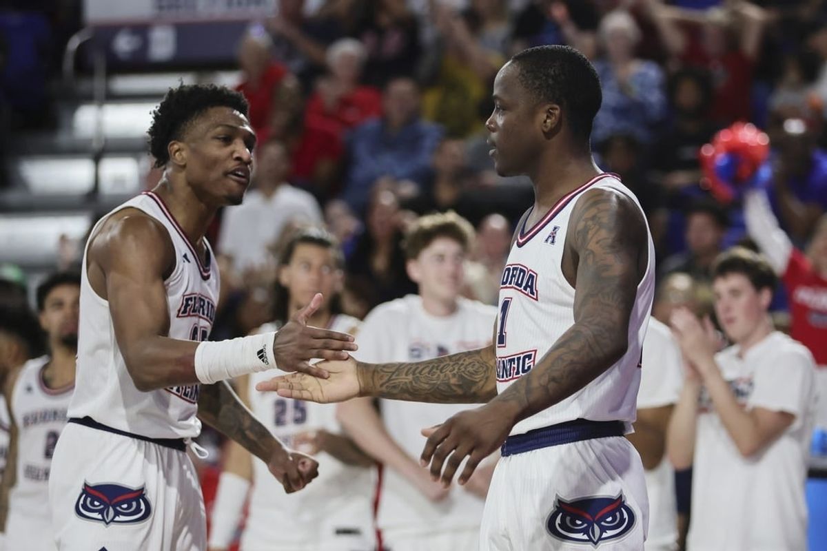 Jan 28, 2024; Boca Raton, Florida, USA; Florida Atlantic Owls guard Johnell Davis (1) celebrates with guard Brandon Weatherspoon (23) against the North Texas Mean Green during the second half at Eleanor R. Baldwin Arena.