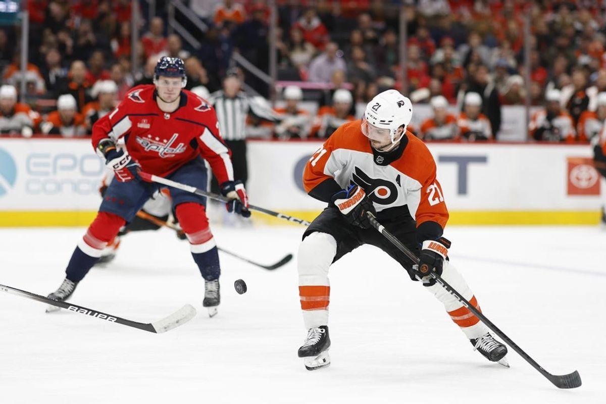 Mar 1, 2024; Washington, District of Columbia, USA; Philadelphia Flyers center Scott Laughton (21) skates with the puck as Washington Capitals center Aliaksei Protas (21) chases in the second period at Capital One Arena.