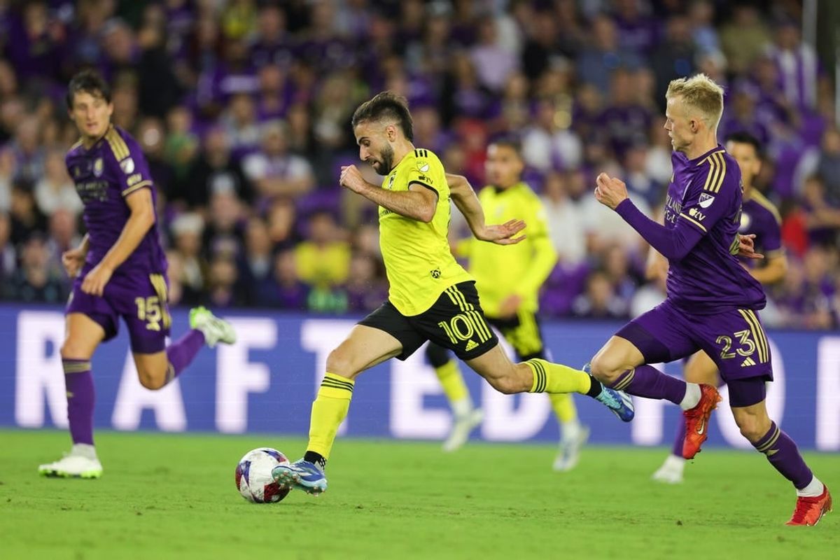 Nov 25, 2023; Orlando, Florida, USA; Columbus Crew forward Diego Rossi (10) dribbles the ball as Orlando City midfielder Dagur Dan Thorhallsson (23) defends during the second half in a MLS Cup Eastern Conference Semifinal match at Exploria Stadium.