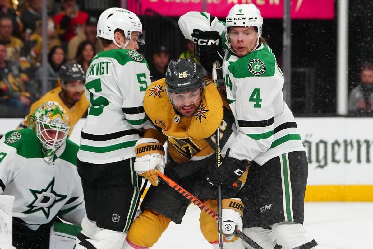 May 3, 2024; Las Vegas, Nevada, USA; Vegas Golden Knights left wing William Carrier (28) is checked by Dallas Stars defenseman Nils Lundkvist (5) and defenseman Miro Heiskanen (4) during the first period of game six of the first round of the 2024 Stanley Cup Playoffs at T-Mobile Arena.
