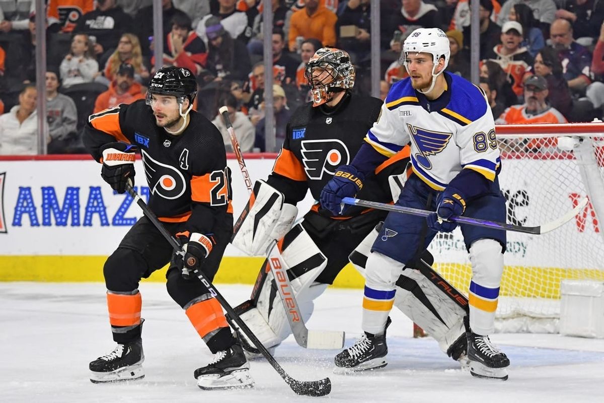 Mar 4, 2024; Philadelphia, Pennsylvania, USA; Philadelphia Flyers center Scott Laughton (21) and goaltender Samuel Ersson (33) battle for position with St. Louis Blues left wing Pavel Buchnevich (89) during the first period at Wells Fargo Center.