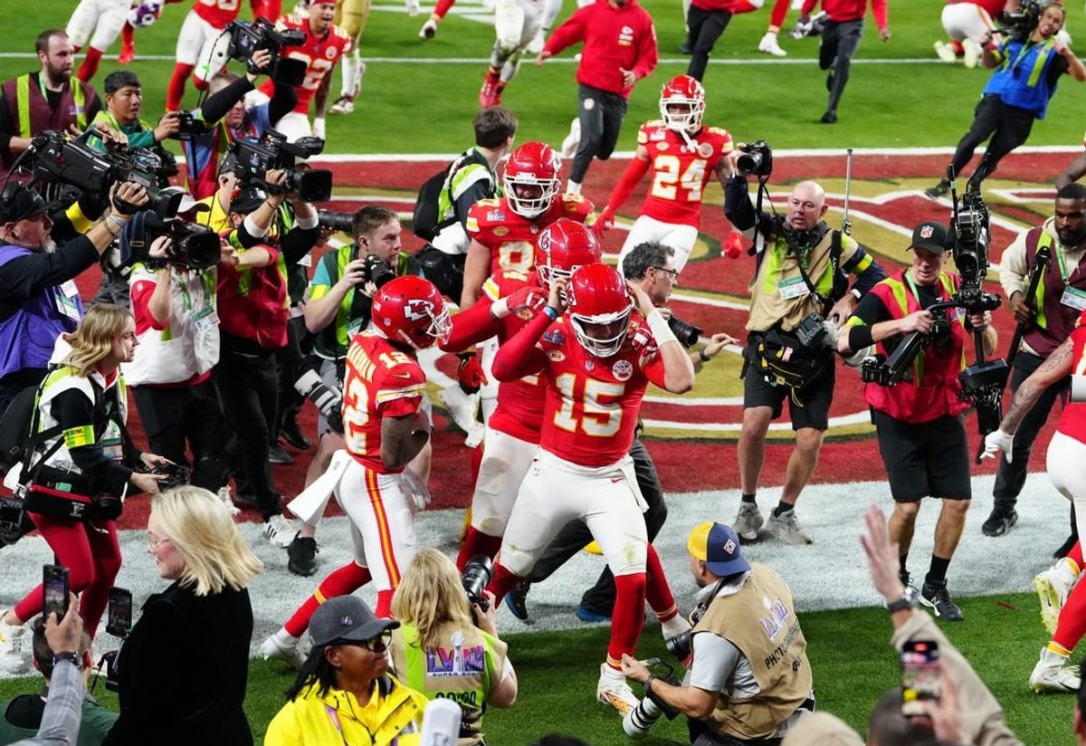 Feb 11, 2024; Paradise, Nevada, USA; Kansas City Chiefs quarterback Patrick Mahomes (15) celebrates after throwing the winning touchdown to wide receiver Mecole Hardman Jr. (12) during overtime against the San Francisco 49ers in Super Bowl LVIII at Allegiant Stadium.