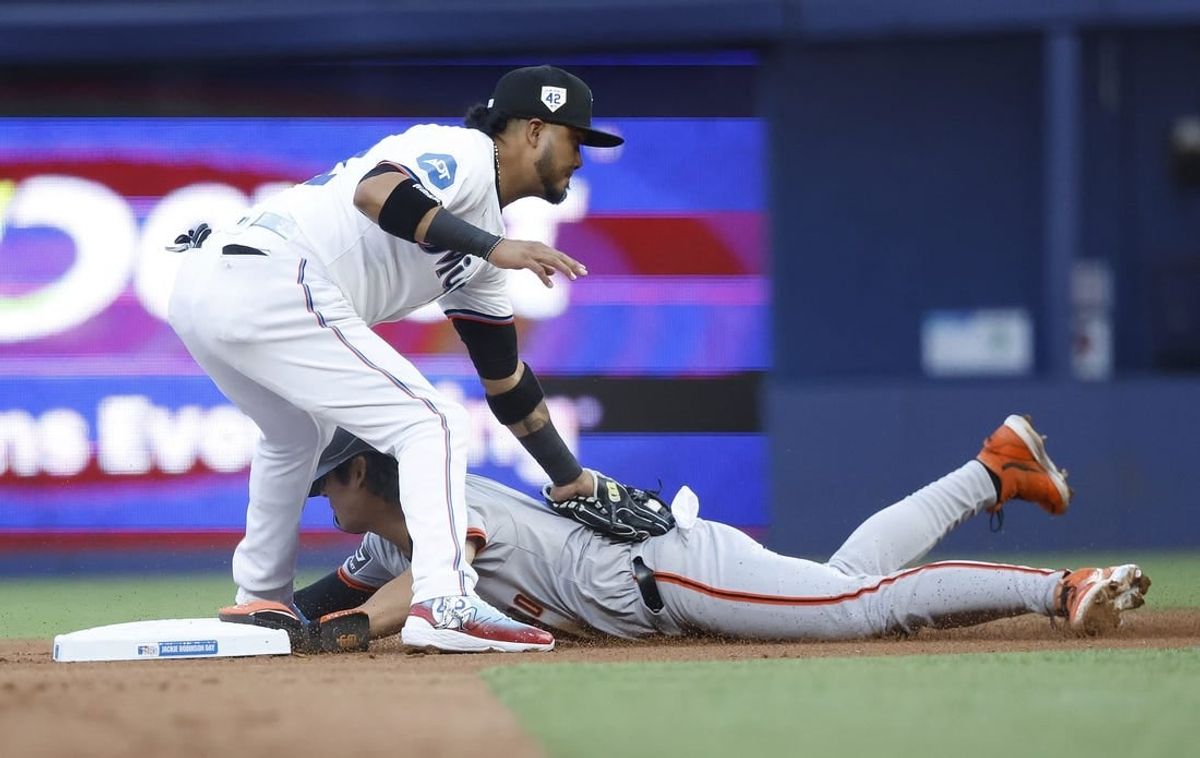 Apr 15, 2024; Miami, Florida, USA; San Francisco Giants outfielder Jung Hoo Lee (51) is tagged out at second base by Miami Marlins second baseman Luis Arraez (3) in the first inning at loanDepot Park.