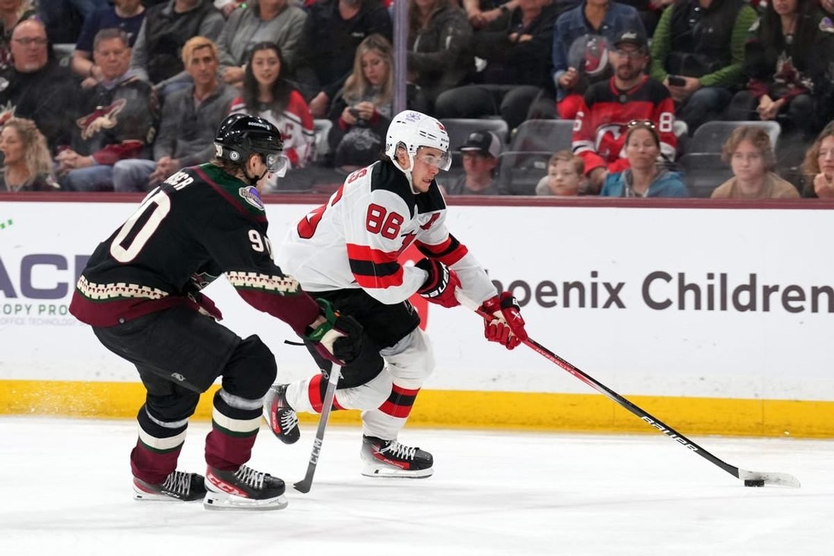 Mar 16, 2024; Tempe, Arizona, USA; New Jersey Devils center Jack Hughes (86) skates against Arizona Coyotes defenseman J.J. Moser (90) during the third period at Mullett Arena.