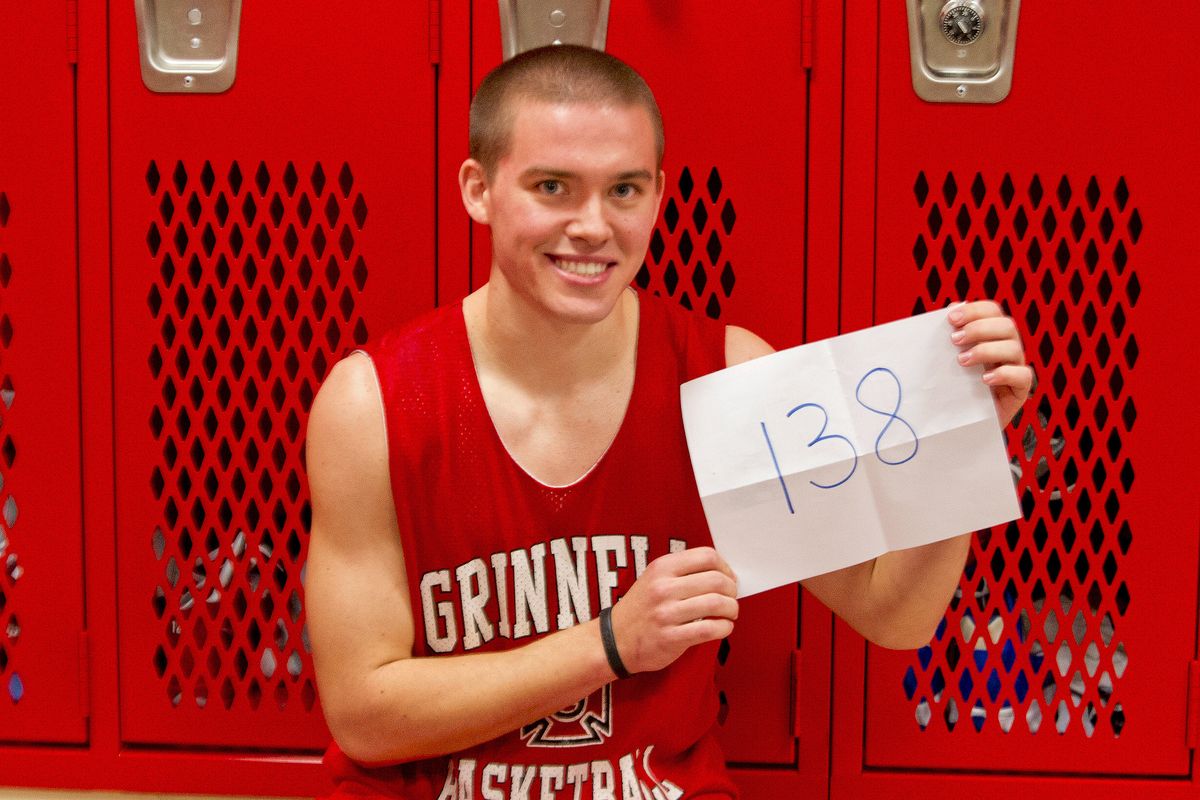 Grinnell’s Jack Taylor holding up the number of points he scored in a single game.