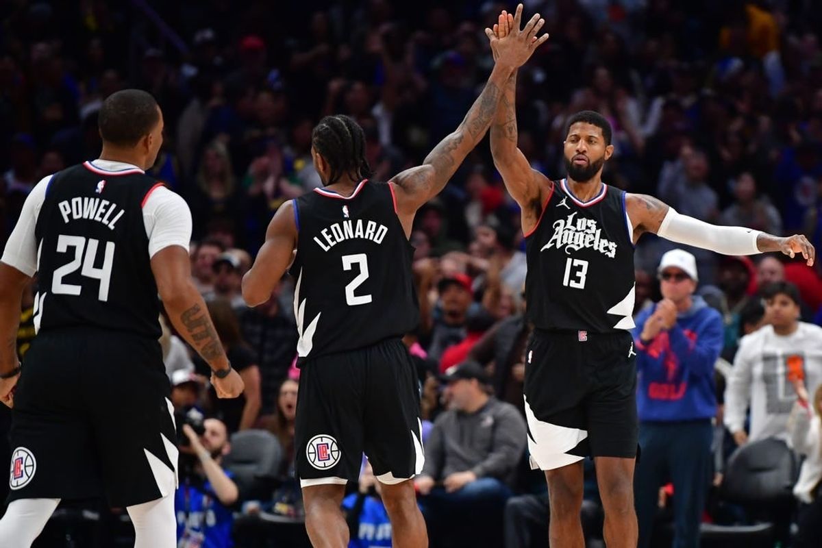 Dec 2, 2023; Los Angeles, California, USA; Los Angeles Clippers forward Paul George (13) celebrates his three point basket scored against the Golden State Warriors with forward Kawhi Leonard (2) and guard Norman Powell (24) during the second half at Crypto.com Arena.