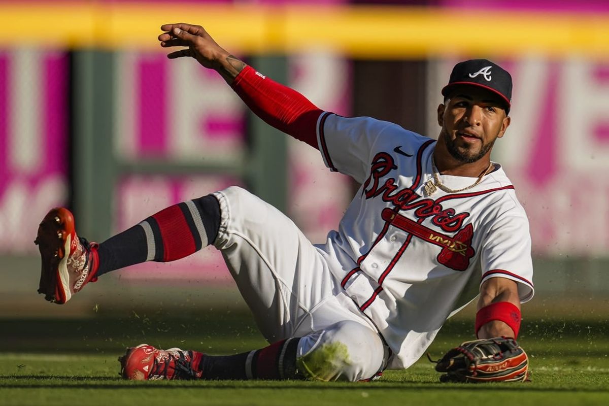 Oct 1, 2023; Cumberland, Georgia, USA; Atlanta Braves left fielder Eddie Rosario (8) makes a sliding catch on a ball hit by Washington Nationals shortstop CJ Abrams (5) (not shown) during the eighth inning at Truist Park.