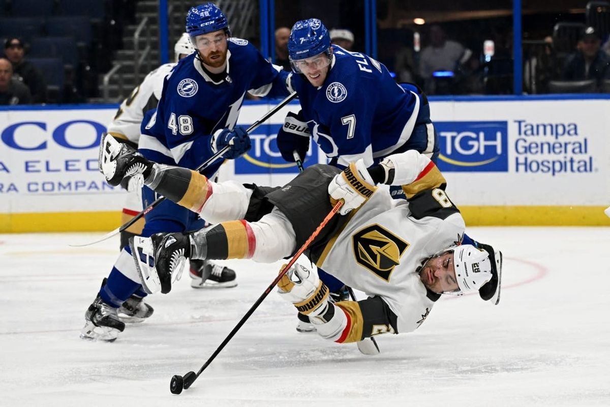 Dec 21, 2023; Tampa, Florida, USA; Las Vegas Golden Knights left wing William Carrier (28) attempts to gain control of the puck in the second period against the Tampa Bay Lightning at Amalie Arena.