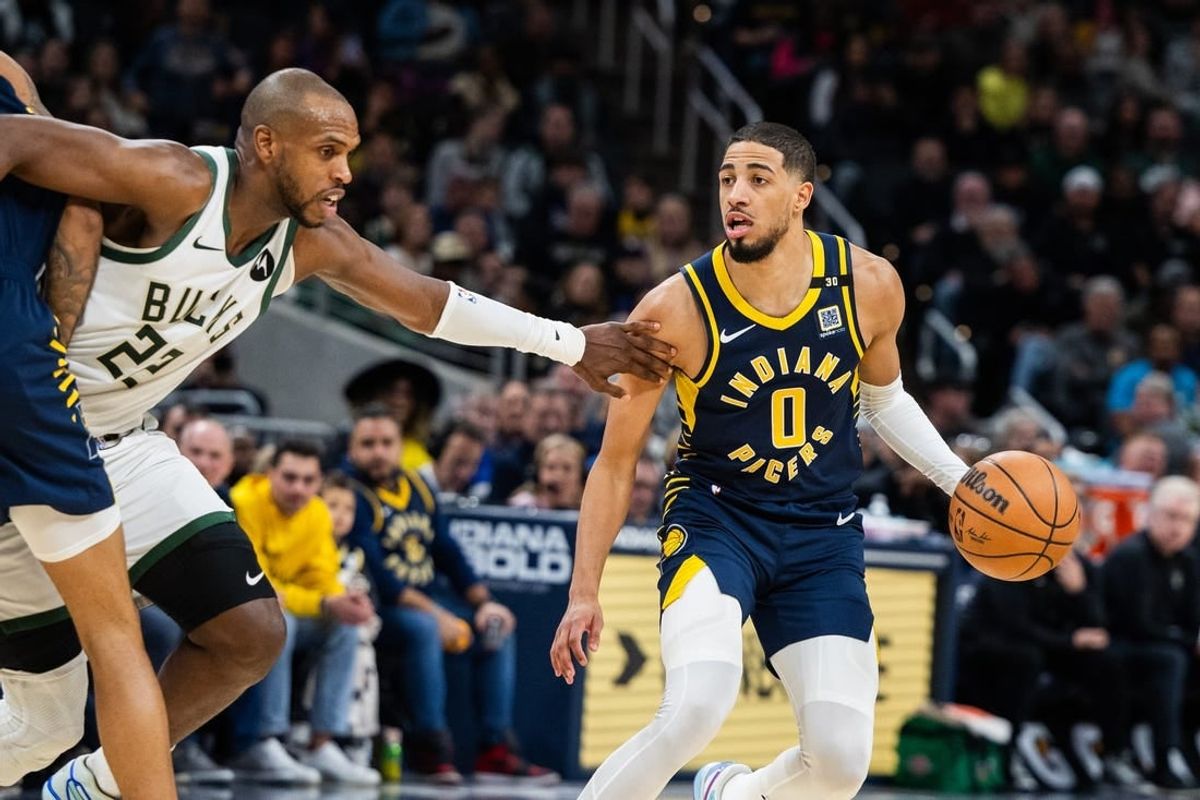 Jan 3, 2024; Indianapolis, Indiana, USA; Indiana Pacers guard Tyrese Haliburton (0) dribbles the ball while Milwaukee Bucks forward Khris Middleton (22) defends in the second half at Gainbridge Fieldhouse.