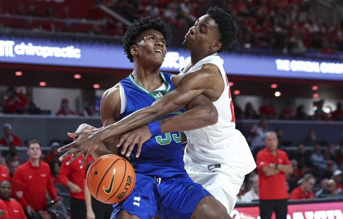 Nov 11, 2023; Houston, Texas, USA; Houston Cougars guard Terrance Arceneaux (23) attempts to steal the ball from Texas A&M-CC Islanders forward Garry Clark (33) during the first half at Fertitta Center.