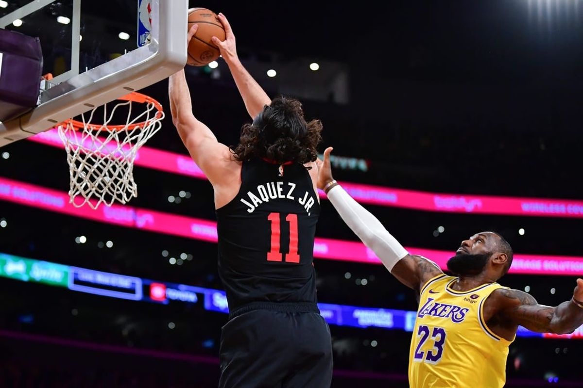 Jan 3, 2024; Los Angeles, California, USA; Miami Heat guard Jaime Jaquez Jr. (11) moves to the basket against Los Angeles Lakers forward LeBron James (23) during the first half at Crypto.com Arena.