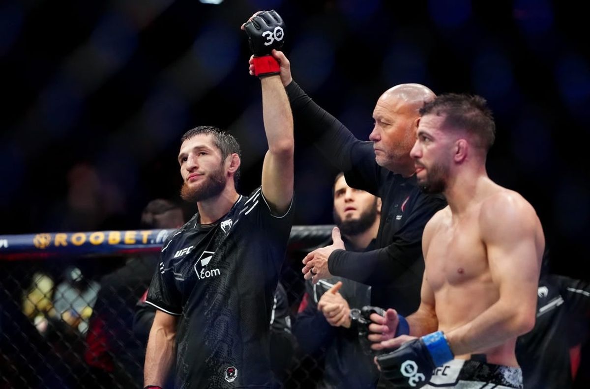 Dec 16, 2023; Las Vegas, Nevada, USA; Tagir Ulanbekov (red gloves) reacts after defeating Cody Durden (blue gloves) during UFC 296 at T-Mobile Arena.
