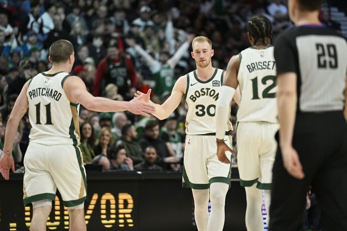 Mar 11, 2024; Portland, Oregon, USA; Boston Celtics forward Sam Hauser (30) celebrates with teammates guard Payton Pritchard (11), and forward Oshae Brissett (12) during the second half against the Portland Trail Blazers at Moda Center.