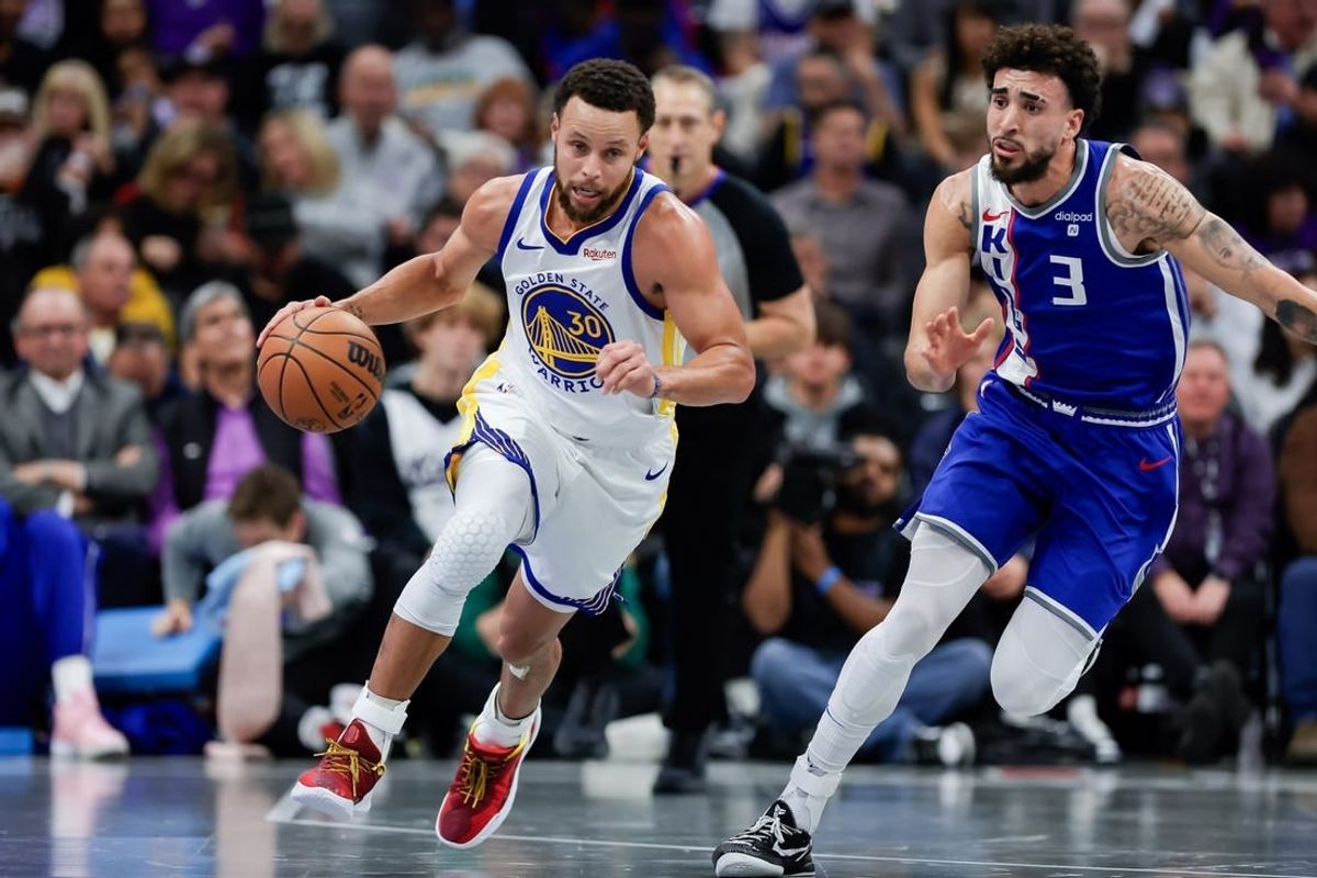 Nov 28, 2023; Sacramento, California, USA; Golden State Warriors guard Stephen Curry (30) dribbles past Sacramento Kings guard Chris Duarte (3) during the fourth quarter at Golden 1 Center.