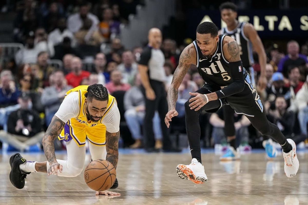 Jan 30, 2024; Atlanta, Georgia, USA; Los Angeles Lakers guard D'Angelo Russell (1) loses and dives for the ball next to Atlanta Hawks guard Dejounte Murray (5) during the second half at State Farm Arena.