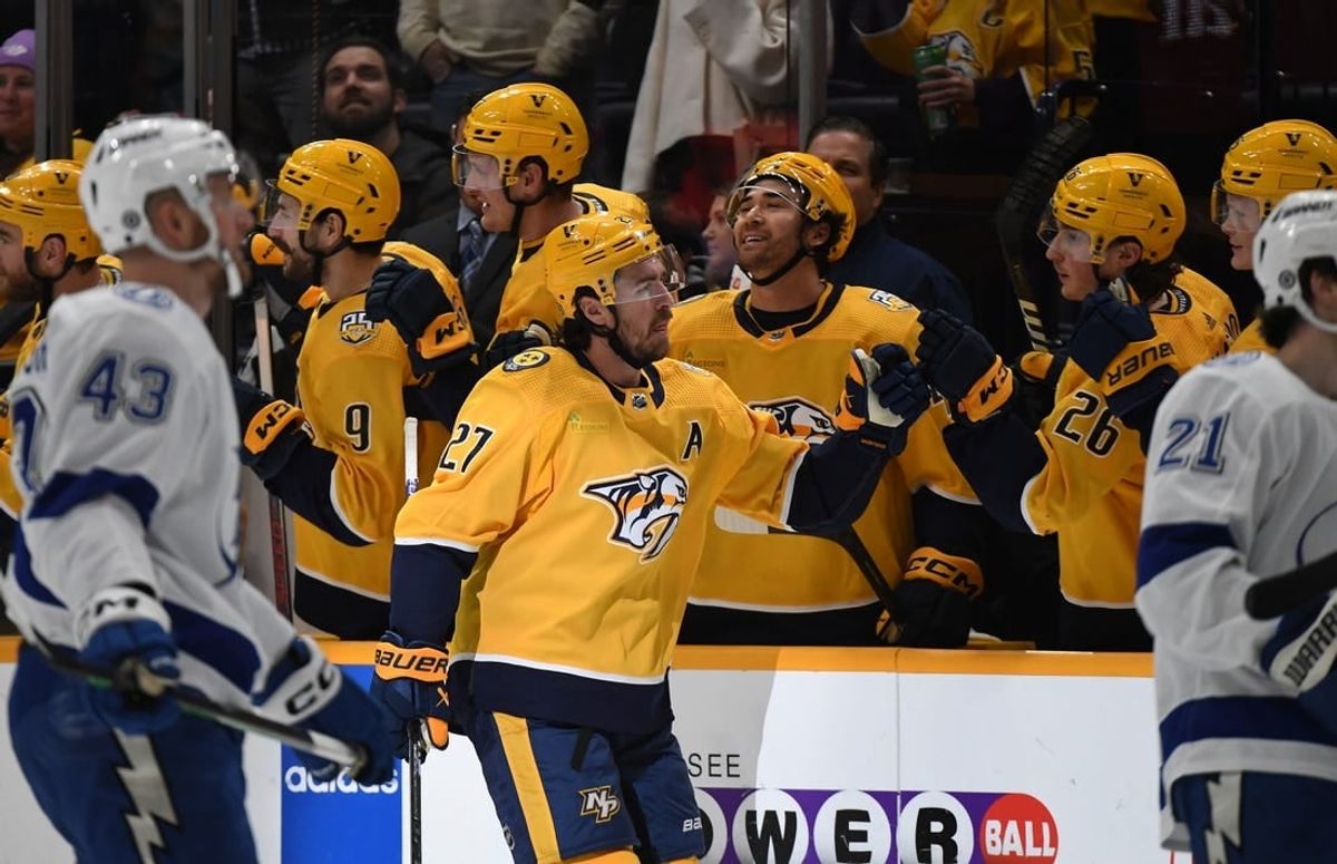 Dec 7, 2023; Nashville, Tennessee, USA; Nashville Predators defenseman Ryan McDonagh (27) is congratulated by teammates after a goal during the second period against the Tampa Bay Lightning at Bridgestone Arena.