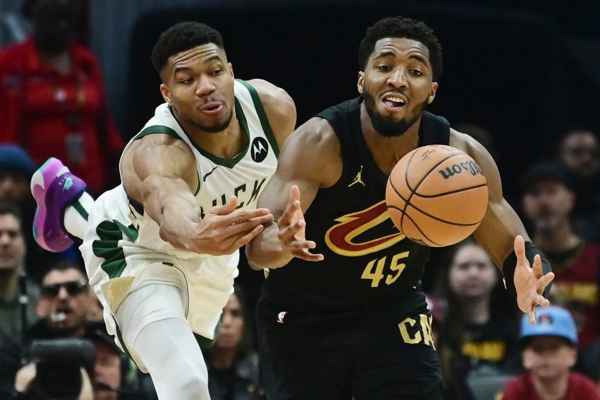 Dec 29, 2023; Cleveland, Ohio, USA; Milwaukee Bucks forward Giannis Antetokounmpo (34) and Cleveland Cavaliers guard Donovan Mitchell (45) go for a loose ball during the first half at Rocket Mortgage FieldHouse.