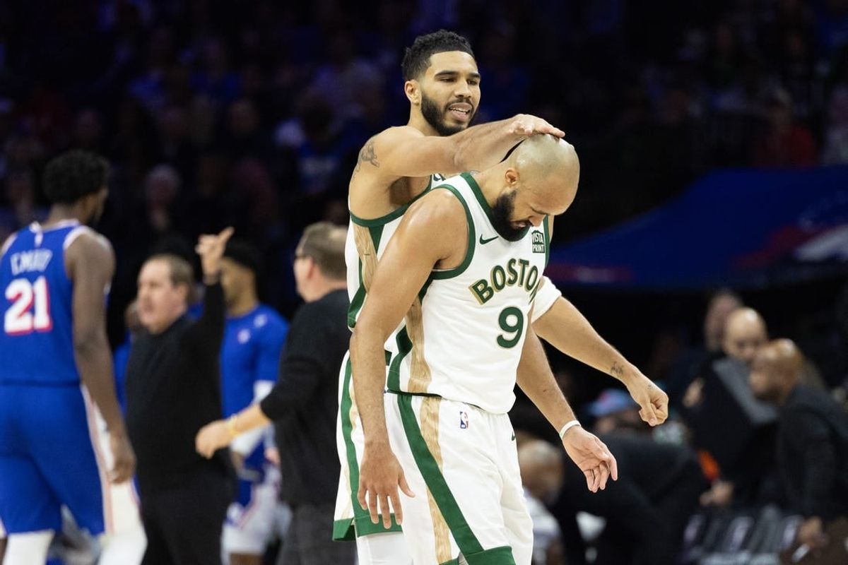 Nov 15, 2023; Philadelphia, Pennsylvania, USA; Boston Celtics forward Jayson Tatum (0) congratulates guard Derrick White (9) after his three pointer against the Philadelphia 76ers during the fourth quarter at Wells Fargo Center.
