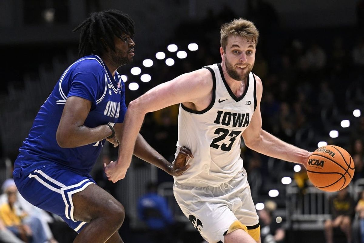 Nov 24, 2023; La Jolla, California, USA; Iowa Hawkeyes forward Ben Krikke (23) dribbles the ball while defended by Seton Hall Pirates center Jaden Bediako (15) during the first half at LionTree Arena.