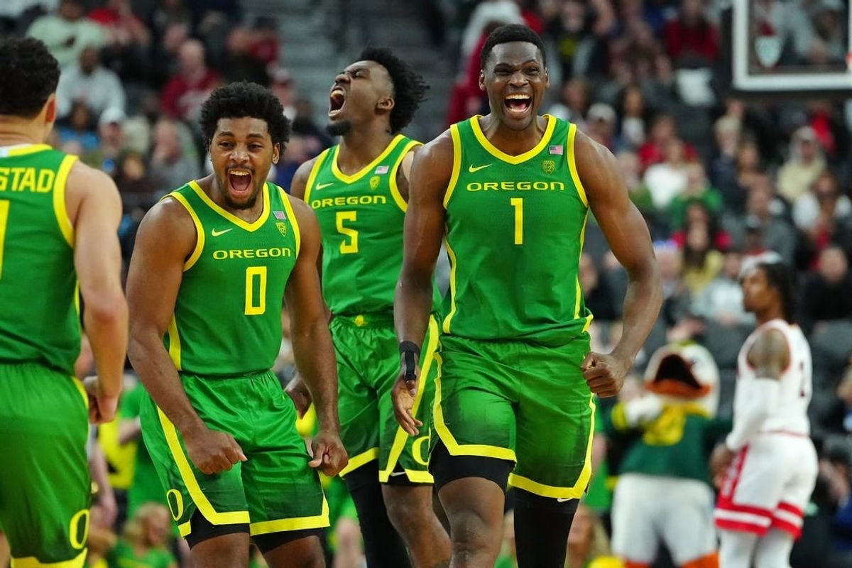 Mar 15, 2024; Las Vegas, NV, USA; Oregon Ducks center N'Faly Dante (1) celebrates with Oregon Ducks guard Kario Oquendo (0), and Oregon Ducks guard Jermaine Couisnard (5) after making a play against the Arizona Wildcats during the second half at T-Mobile Arena.