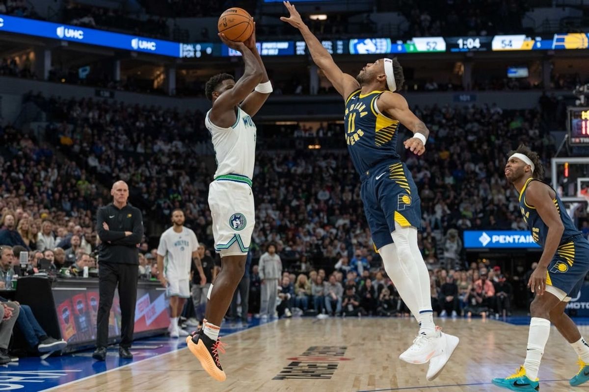 Dec 16, 2023; Minneapolis, Minnesota, USA; Minnesota Timberwolves guard Anthony Edwards (5) hits a three point basket defended by Indiana Pacers forward Bruce Brown (11) in the second quarter at Target Center.